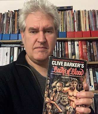 Paul Kane, holding volume 1-3 of Clive Barker's Books of Blood