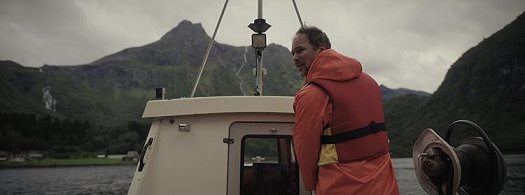 Still from the Colour of Madness - man on boat