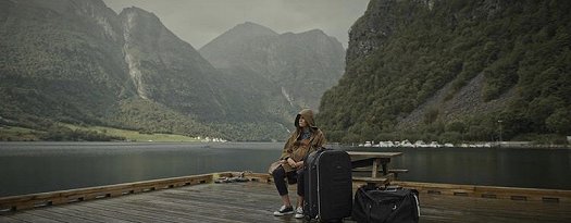 Still from the Colour of Madness - woman sitting by water