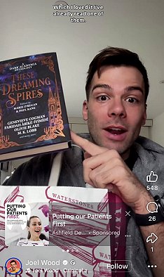 screenshot of Joel Wood holding up a copy of These Dreaming Spires, edited by Marie O'Regan and Paul Kane