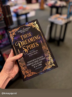 photograph someone in a book store's hand holding up a copy of These Dreaming Spires, edited by Marie O'Regan and Paul Kane