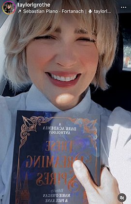 photograph of a smiling Taylor Grothe holding up a copy of These Dreaming Spires, edited by Marie O'Regan and Paul Kane