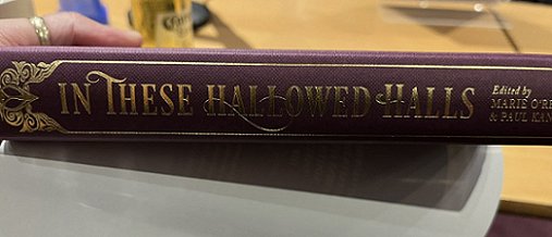 Image showing the gold lettering on the spine of a copy of In These Hallowed Halls, edited by Marie O'Regan and Paul Kane