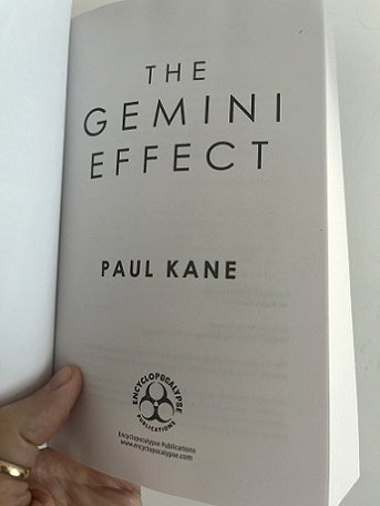 image of a man's hand holding a copy of The Gemini Effect, by Paul Kane, open to the Title page