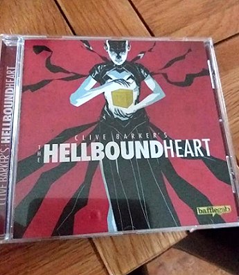 image showing a copy of the full-cast audio version of Clive Barker's The Hellbound Heart, scripted by Paul Kane. Cover features a cenobite about to open a puzzle box against a red background