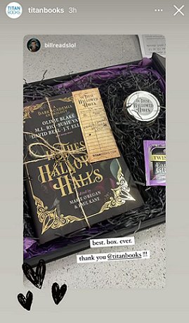 screenshot of @titanbooks Instagram showing a copy of In These Hallowed Halls tied up with string and a bookmark, beside a teabag and scented candle in a black box lined with purple tissue and shredded black tissue