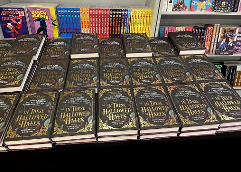 A display of many copies of In These Hallowed Halls, edited by Marie O'Regan and Paul Kane, on a table at Forbidden Planet London Megastore