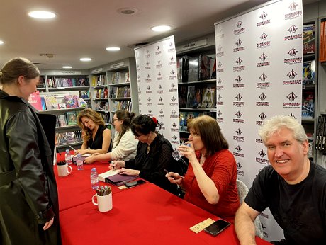 The signing table. L to R: Kate Weinberg, Tori Bovalino, Helen Grant, Marie O'Regan (drinking from a bottle of water) and a smiling Paul Kane