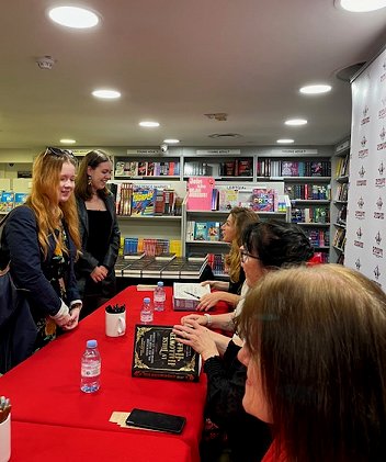 Customers talking to authors at the signing. In the foreground, Marie O'Regan, behind her you can see Helen Grant and Kate Weinberg talking to customers