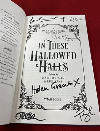Photo of a signed title page of In These Hallowed Halls, edited by Marie O'Regan. Signed by JT Ellison, Helen Grant, Tori Bovalino, Kate Weinberg, Marie O'Regan and Paul Kane