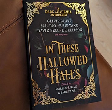 photograph of a copy of In These Hallowed Halls, edited by Marie O'Regan and Paul Kane, lying on a brown leather surface