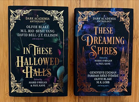 L to R: A copy of In These Hallowed Halls, and a copy of These Dreaming Spires, both edited by Marie O'Regan and Paul Kane, on a wooden surface
