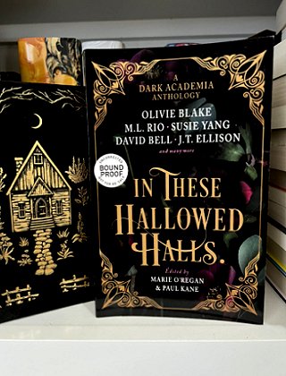 A shelf featuring a standing copy of In These Hallowed Halls, edited by Marie O'Regan and Paul Kane