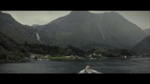 Still from Sacrifice, boat on lake, mountain in background