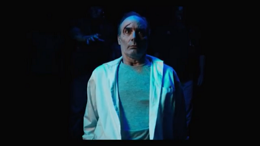 Still from the torturer, injured man staring at camera