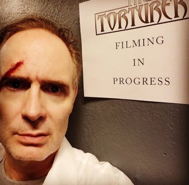 Paul T Taylor with sign: Filming in progress