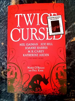 copy of a book, Twice Cursed, edited by Marie O'Regan and Paul Kane. Featuring a signed sticker from Forbidden Planet.