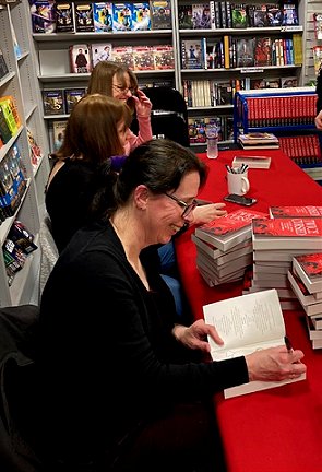 Helen Grant, Marie O'Regan and Laura Purcell signing copies of Twice Cursed