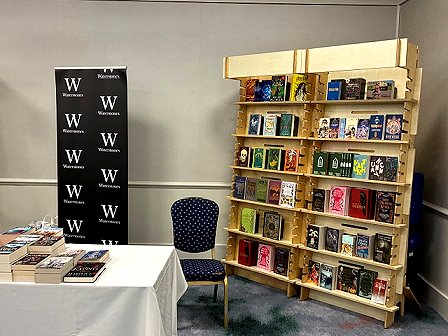 photograph showing a signing area beside the book display for the Waterstones Dealers tables at WFC 2025