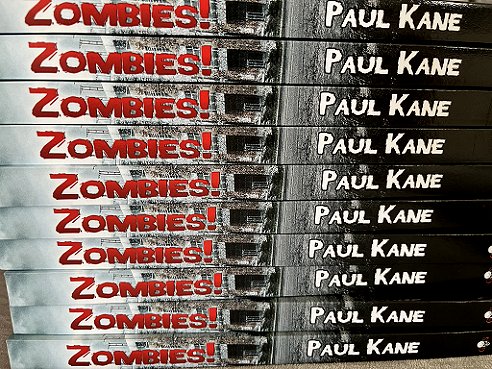 Pile of copies of ZOmbies! by Paul Kane, showing the book spines
