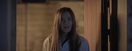 Still from the Colour of Madness - woman in doorway