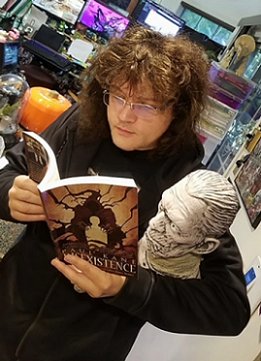 Jason V. Brock with a copy of Disexistence, by Paul Kane